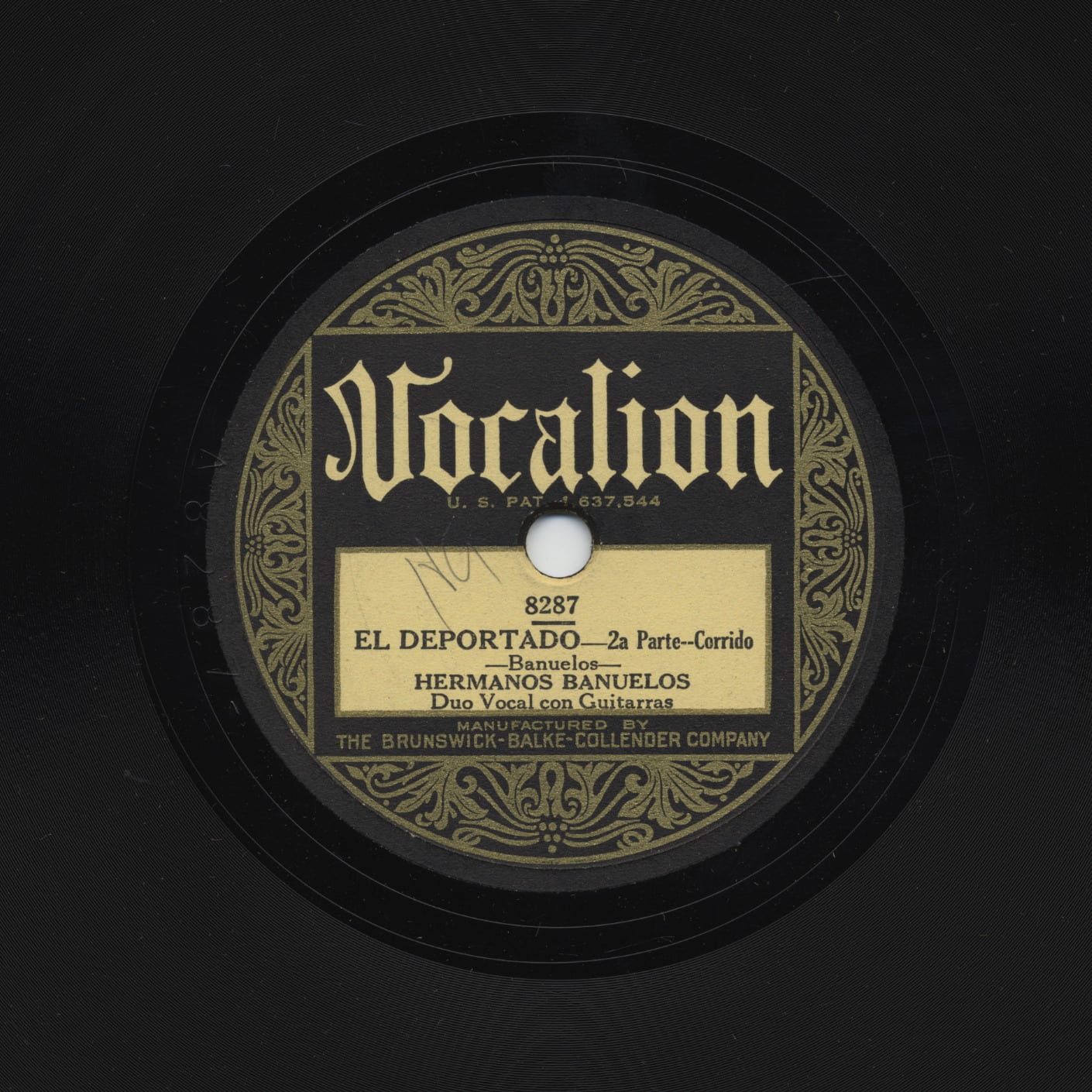 A black record with ornate gold design called "vocalion"